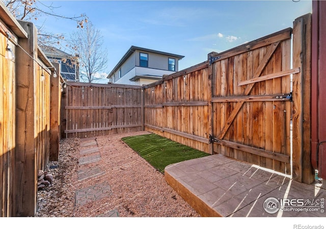 view of yard featuring a patio area and a fenced backyard