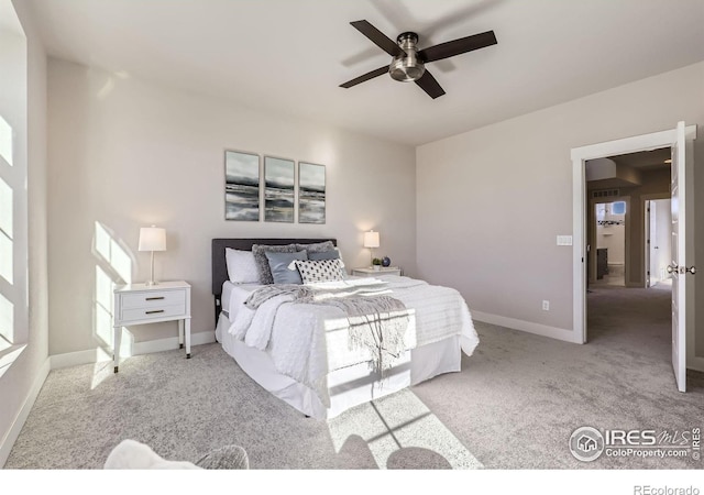 bedroom with ceiling fan, carpet flooring, and baseboards