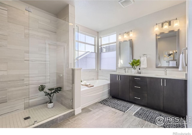 full bathroom with a garden tub, a sink, visible vents, a shower stall, and double vanity