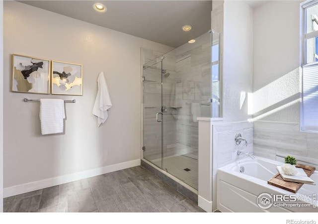 full bath featuring a garden tub, recessed lighting, a shower stall, and baseboards