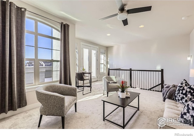 carpeted living area with baseboards and recessed lighting