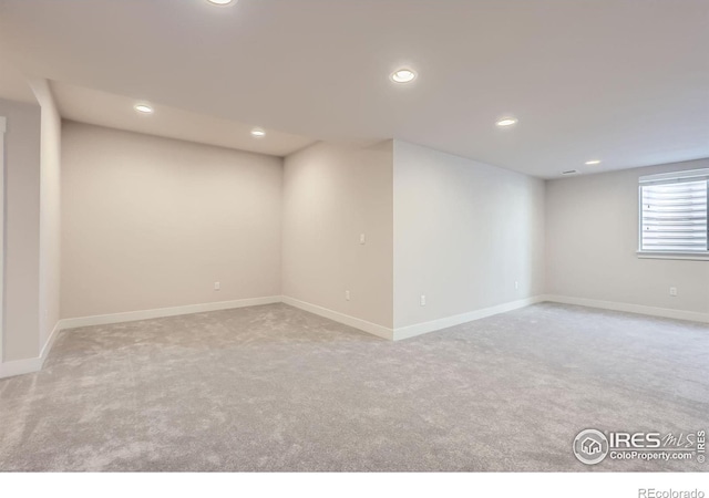 basement featuring carpet floors, baseboards, and recessed lighting