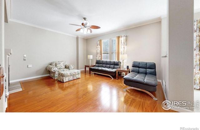 7145 Brittany Dr, Fort Collins, CO 80525 - living room featuring crown molding, ceiling fan, wood finished floors, and baseboards