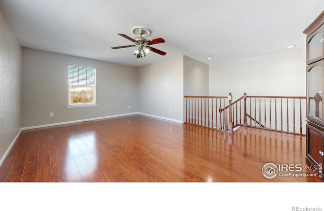 7145 Brittany Dr, Fort Collins, CO 80525 - empty room with a ceiling fan, wood finished floors, baseboards, and recessed lighting