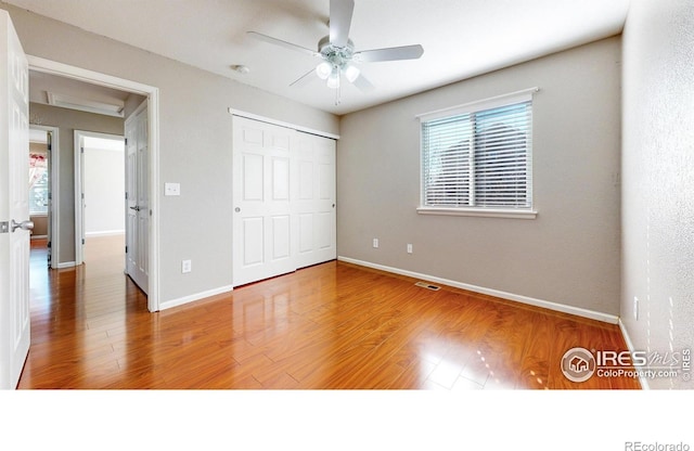 7145 Brittany Dr, Fort Collins, CO 80525 - unfurnished bedroom with wood finished floors, baseboards, a closet, and a ceiling fan