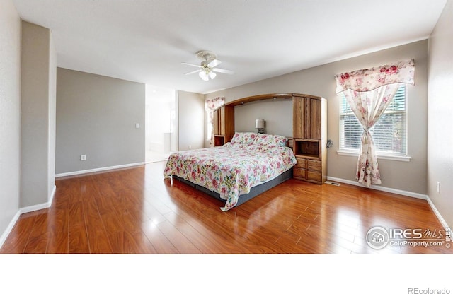 7145 Brittany Dr, Fort Collins, CO 80525 - bedroom featuring wood finished floors, baseboards, and ceiling fan