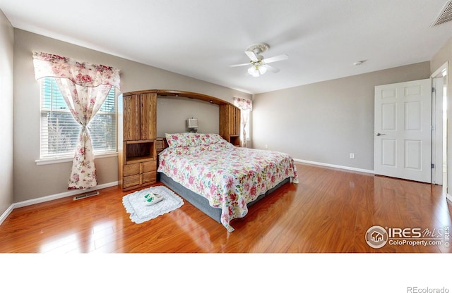7145 Brittany Dr, Fort Collins, CO 80525 - bedroom with wood finished floors, baseboards, and ceiling fan