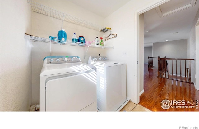 7145 Brittany Dr, Fort Collins, CO 80525 - laundry room featuring independent washer and dryer, wood finished floors, attic access, and baseboards