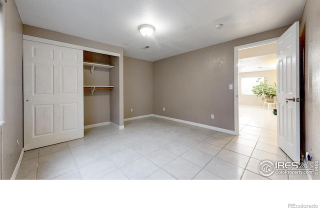 7145 Brittany Dr, Fort Collins, CO 80525 - unfurnished bedroom featuring light tile patterned floors, a closet, and baseboards