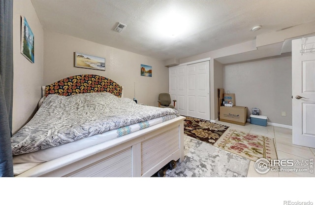 7145 Brittany Dr, Fort Collins, CO 80525 - bedroom featuring light tile patterned floors, a closet, and baseboards