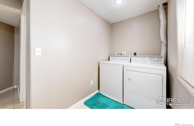 7145 Brittany Dr, Fort Collins, CO 80525 - clothes washing area with washing machine and dryer and baseboards