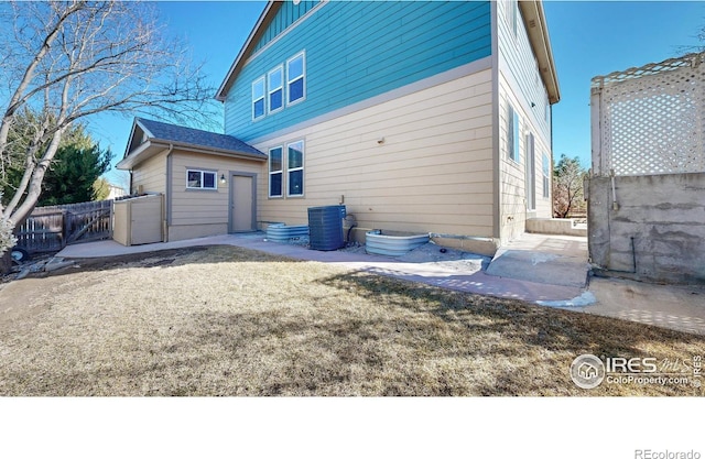 7145 Brittany Dr, Fort Collins, CO 80525 - rear view of house with a garage, fence, and central AC