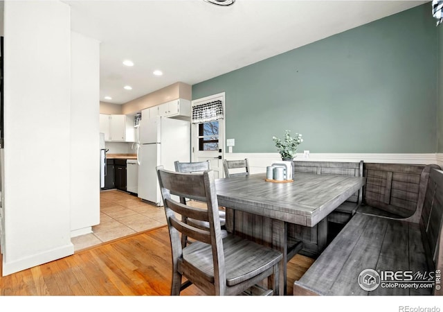 dining space with recessed lighting and light wood-style flooring