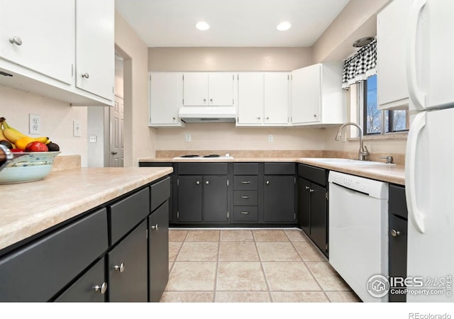 kitchen featuring light countertops, white cabinetry, a sink, white appliances, and under cabinet range hood