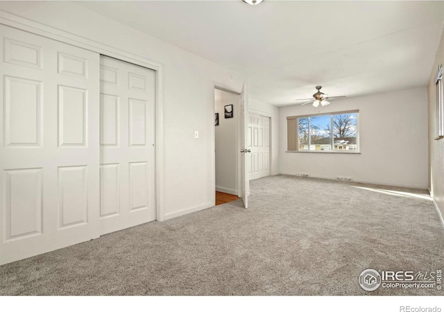 unfurnished bedroom with carpet floors and baseboards