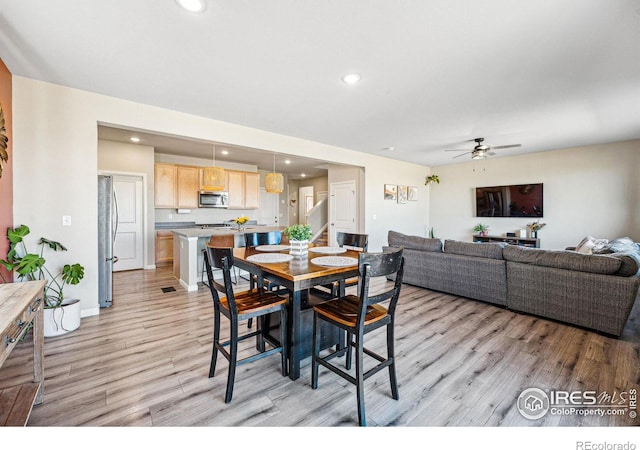 dining room featuring stairs, ceiling fan, recessed lighting, and light wood-style floors