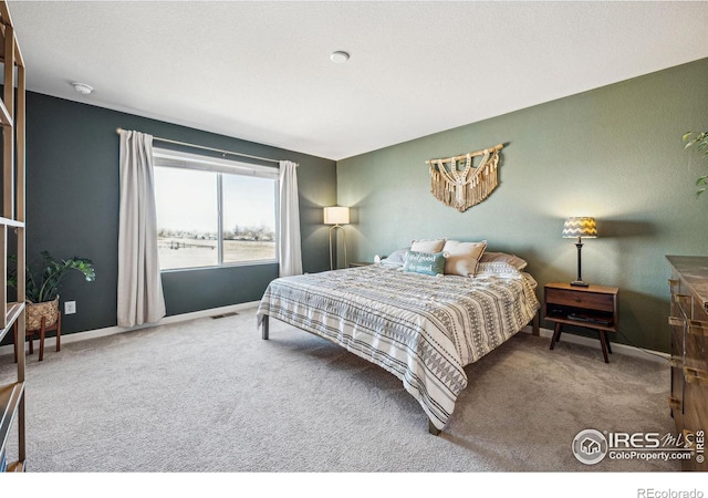 carpeted bedroom featuring baseboards