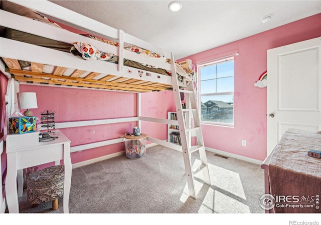 carpeted bedroom featuring visible vents and baseboards