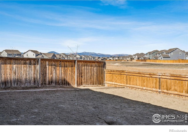 view of yard with a fenced backyard and a residential view