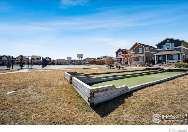 view of home's community with a residential view and fence