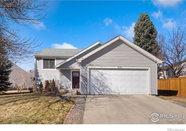 view of front of house with a garage, driveway, a front yard, and fence