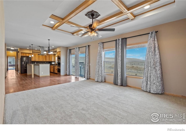 unfurnished living room with carpet floors, coffered ceiling, ceiling fan, and baseboards