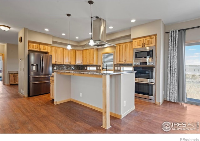 kitchen featuring wood finished floors, appliances with stainless steel finishes, island exhaust hood, and decorative backsplash