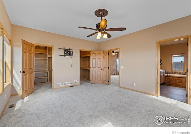 unfurnished bedroom featuring carpet, visible vents, and baseboards