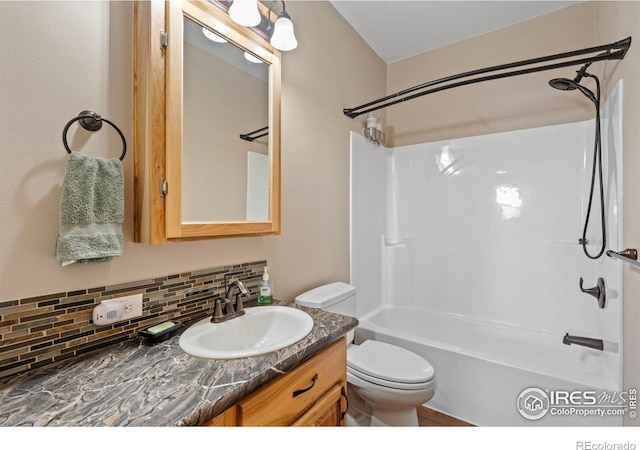 bathroom with shower / bathing tub combination, backsplash, toilet, and vanity