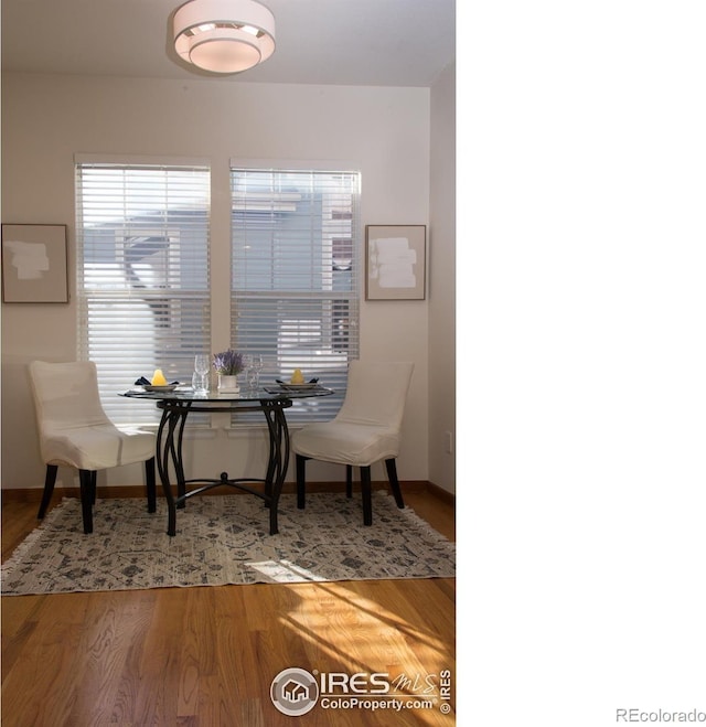 dining room featuring wood finished floors and baseboards