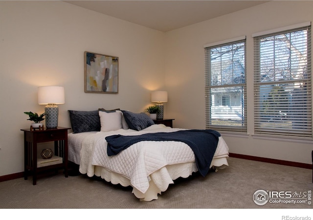 carpeted bedroom with baseboards