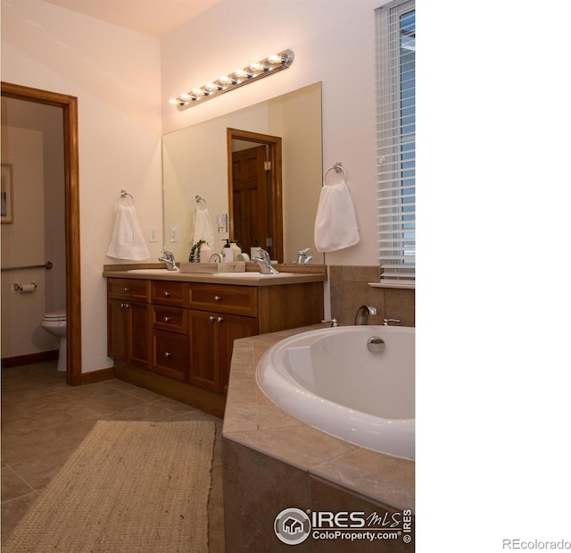 full bath with a garden tub, double vanity, toilet, a sink, and tile patterned floors