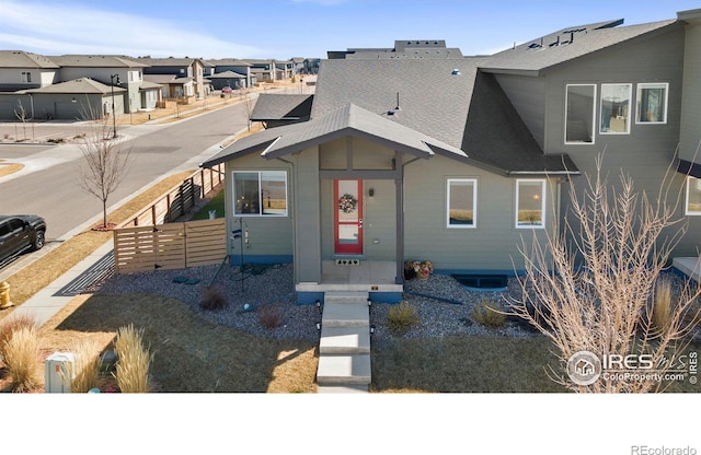 view of front of house featuring fence and a residential view