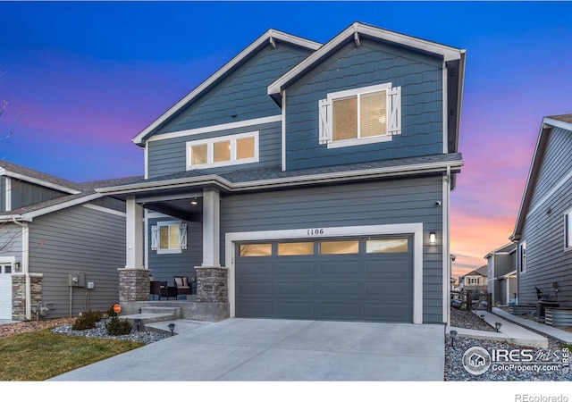 craftsman house with a garage and driveway