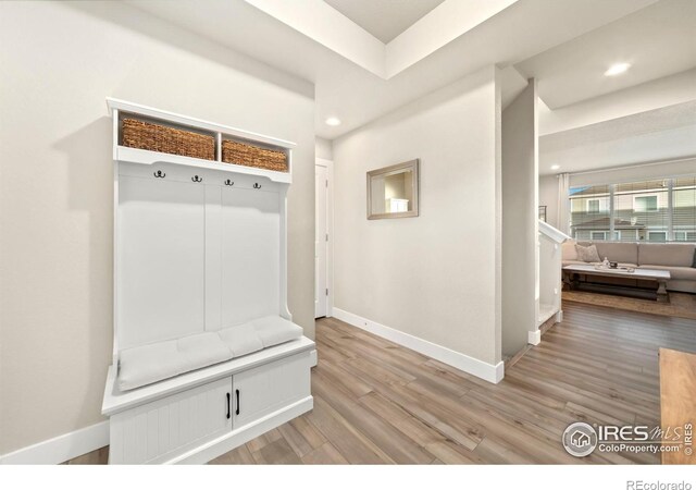 mudroom featuring recessed lighting, baseboards, and light wood finished floors