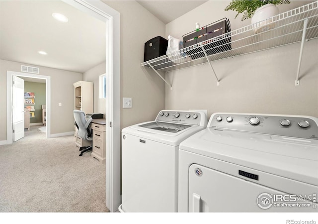 clothes washing area featuring light carpet, laundry area, baseboards, visible vents, and washer and dryer