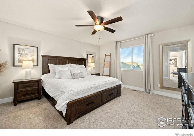 bedroom with a ceiling fan, light colored carpet, visible vents, and baseboards