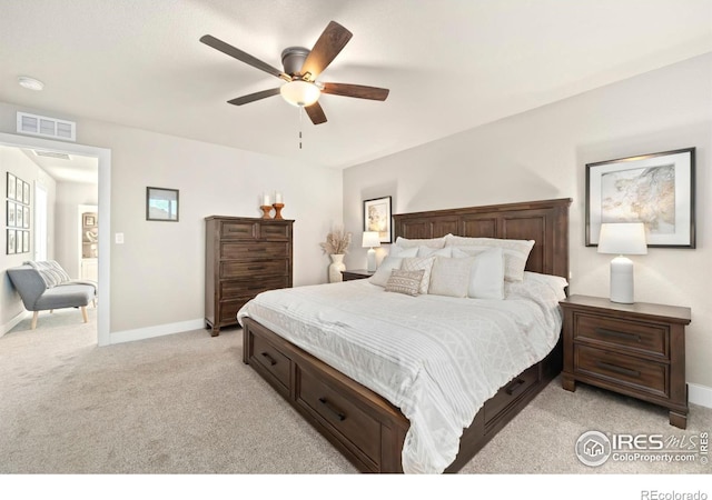 bedroom featuring baseboards, ceiling fan, visible vents, and light colored carpet