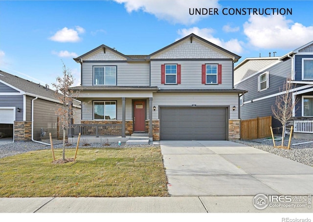 craftsman house with a porch, a garage, concrete driveway, stone siding, and a front lawn