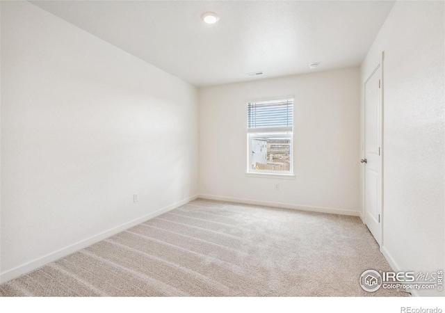 unfurnished room featuring carpet flooring and baseboards