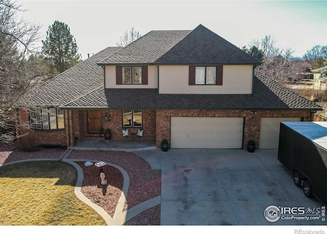 traditional-style home with driveway, a garage, and brick siding