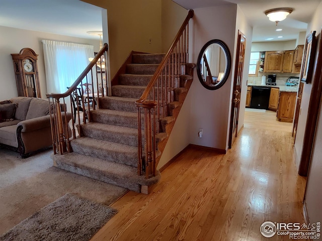 staircase featuring baseboards and wood finished floors