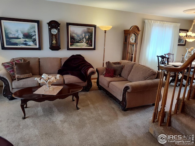 living room with carpet floors, stairway, and a notable chandelier