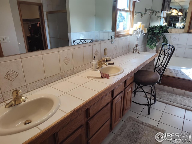 bathroom with double vanity, tile patterned flooring, and a sink