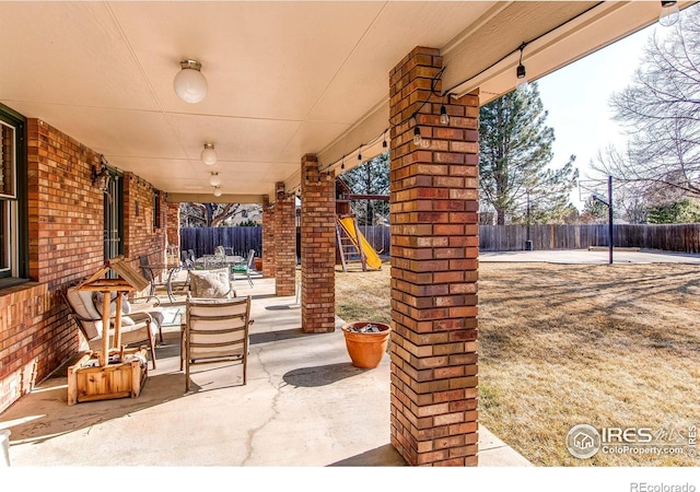 view of patio / terrace with a fenced backyard and a playground