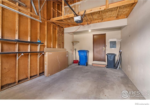 garage featuring electric panel and a garage door opener