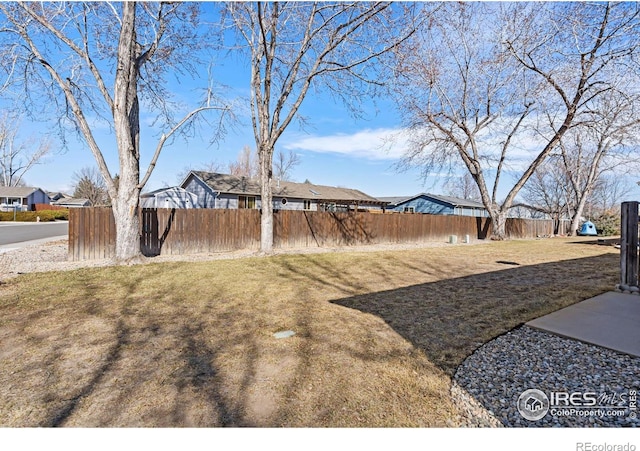 view of yard featuring a residential view and fence