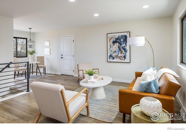 living area featuring recessed lighting, baseboards, and wood finished floors