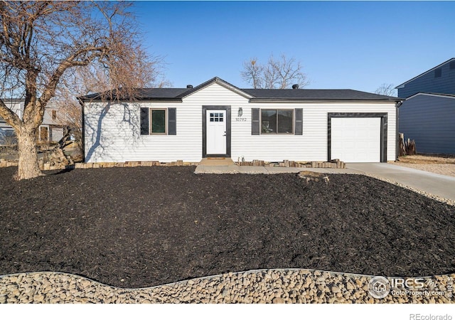 10792 Moore St, Broomfield, CO 80021 - single story home featuring concrete driveway, a garage, and roof mounted solar panels