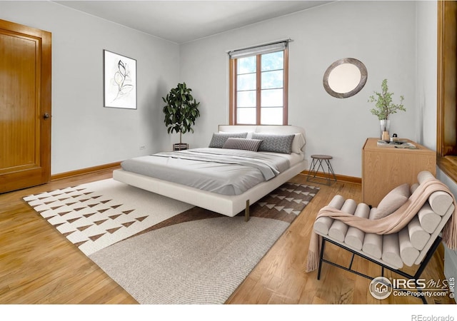 bedroom featuring baseboards and wood finished floors